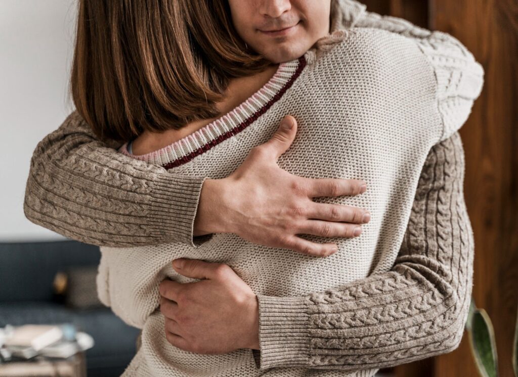 Woman hugging man for emotional support
