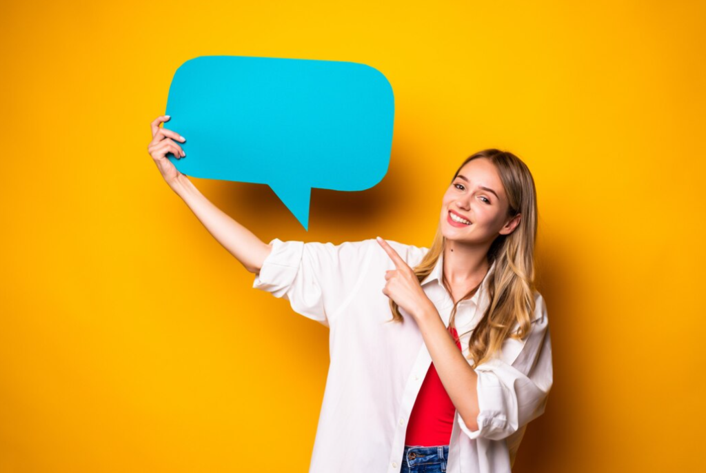 A woman points to a large blue speech bubble against a sunny yellow background