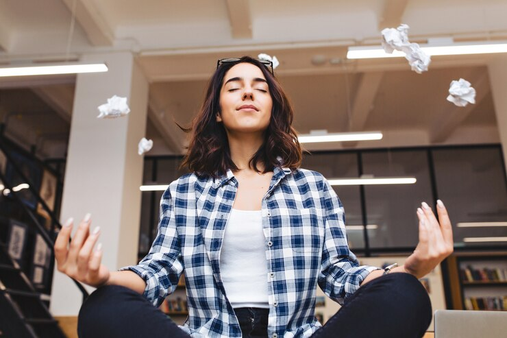 Woman Relaxing in Office Around Flying Papers